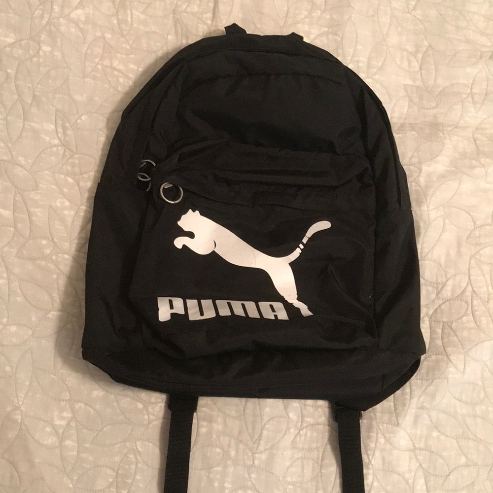 Medium sized black and green puma backpack.
